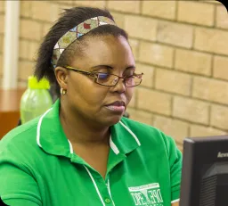 Lady with glasses looking at a computer screen