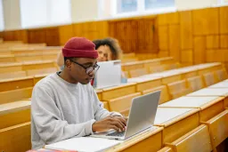 Young man typing a laptop
